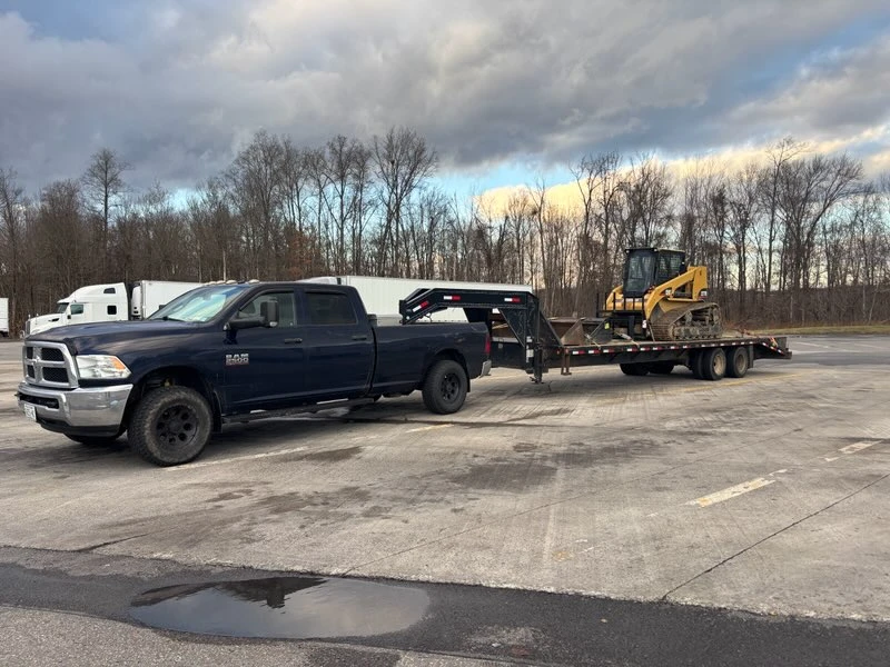 SMH Excavation truck transporting skid steer for residential project